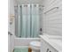Bright bathroom featuring a tub with a shower and stylish plank walls at 9501 Shore Dr. # D-132, Myrtle Beach, SC 29572