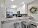 Well-equipped kitchen featuring white cabinets, a breakfast bar, and a modern backsplash at 9501 Shore Dr. # D-132, Myrtle Beach, SC 29572