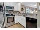 Galley kitchen with stainless steel oven, granite countertops, and a view into the living space at 9501 Shore Dr. # D-132, Myrtle Beach, SC 29572