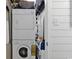 A washer and dryer unit sits next to shelving in this utility space at 9501 Shore Dr. # D-132, Myrtle Beach, SC 29572