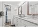 Bright bathroom with double sinks, granite countertop, and shower with blue accents at 101 Ocean Creek Dr. # Mm-5, Myrtle Beach, SC 29572