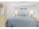 Inviting bedroom featuring a queen bed with beachy decor, bedside tables, and a ceiling fan at 101 Ocean Creek Dr. # Mm-5, Myrtle Beach, SC 29572