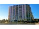 View of the building's exterior with balconies and palm trees at 101 Ocean Creek Dr. # Mm-5, Myrtle Beach, SC 29572