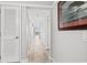 Long hallway with doors leading to rooms and a view of the balcony at 101 Ocean Creek Dr. # Mm-5, Myrtle Beach, SC 29572