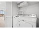A laundry room with a side-by-side washer and dryer and a storage shelf at 101 Ocean Creek Dr. # Mm-5, Myrtle Beach, SC 29572