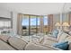 Cozy living room with comfortable seating, ocean view, and access to a balcony at 101 Ocean Creek Dr. # Mm-5, Myrtle Beach, SC 29572