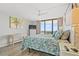 Bright main bedroom featuring a ceiling fan, balcony with ocean views, and coastal-themed décor at 101 Ocean Creek Dr. # Mm-5, Myrtle Beach, SC 29572