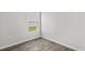 A small bedroom showing wood-look floors, neutral walls, white trim, and a window letting in natural light at 108 Saddle St, Conway, SC 29527