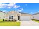 Inviting single-story home with a well manicured lawn, a attached garage, and a modern front door at 108 Saddle St, Conway, SC 29527