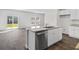 An eat-in kitchen with stainless steel appliances, light countertops, white cabinetry and a view to the back yard at 108 Saddle St, Conway, SC 29527