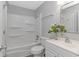A clean bathroom featuring a shower and tub combination, with flower decor on the vanity at 110 Horizon River Dr. # I-2, Myrtle Beach, SC 29588