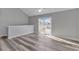 Second floor bedroom with vaulted ceiling, wood-look floors, and sliding glass doors leading to a balcony at 110 Horizon River Dr. # I-2, Myrtle Beach, SC 29588