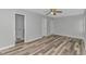 This spacious bedroom has wooden floors, ceiling fan, and an adjoining bathroom at 110 Horizon River Dr. # I-2, Myrtle Beach, SC 29588