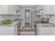 Galley kitchen featuring stainless steel appliances, granite countertops, and white cabinetry with modern hardware at 110 Horizon River Dr. # I-2, Myrtle Beach, SC 29588