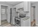Kitchen with stainless steel appliances, granite countertops, white cabinetry, and adjacent doorways at 110 Horizon River Dr. # I-2, Myrtle Beach, SC 29588