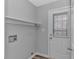 This laundry room has a shelf, wooden floors, and exterior door leading to the backyard at 110 Horizon River Dr. # I-2, Myrtle Beach, SC 29588