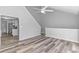 Open-concept living room with hardwood floors, stairway, and a partial view of the updated kitchen at 110 Horizon River Dr. # I-2, Myrtle Beach, SC 29588