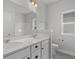Bright bathroom with double vanity sinks, a large mirror, and white cabinets at 1204 Nw Calabash Station Blvd., Calabash, NC 28467