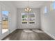 Inviting dining area with natural light, modern chandelier, and view of the outdoors at 1204 Nw Calabash Station Blvd., Calabash, NC 28467