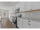 Bright kitchen features white cabinets, stainless steel appliances, and granite countertops at 1204 Nw Calabash Station Blvd., Calabash, NC 28467