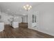 Open-concept living area with views of the kitchen and outdoor patio through a glass door at 1204 Nw Calabash Station Blvd., Calabash, NC 28467