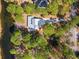 Aerial view of the property nestled among trees, showing a paved driveway and waterfront at 144 Springfield Rd., Pawleys Island, SC 29585