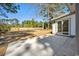 Backyard patio featuring lake and wooded views, with sliding glass doors at 144 Springfield Rd., Pawleys Island, SC 29585