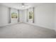 Bright bedroom featuring two large windows with views and a ceiling fan at 144 Springfield Rd., Pawleys Island, SC 29585
