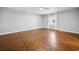 Comfortable bedroom with parquet wood flooring, a ceiling fan, and a large window with bright natural light at 144 Springfield Rd., Pawleys Island, SC 29585