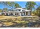 Exterior of home featuring well-manicured lawn, large windows, and sunroom at 144 Springfield Rd., Pawleys Island, SC 29585