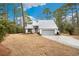 Charming one-story home with a light gray exterior, two-car garage, and well-manicured lawn at 144 Springfield Rd., Pawleys Island, SC 29585