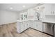 Modern kitchen with white cabinets, quartz countertops, and stainless steel appliances at 144 Springfield Rd., Pawleys Island, SC 29585