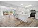 Open kitchen with stainless steel appliances and views of the bright sunroom at 144 Springfield Rd., Pawleys Island, SC 29585