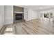 Bright living room with brick fireplace, built-in shelves, and light wood floors at 144 Springfield Rd., Pawleys Island, SC 29585
