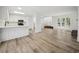Open-concept living space with kitchen, living room, and stairway at 144 Springfield Rd., Pawleys Island, SC 29585