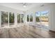 Bright sunroom with multiple glass doors overlooking the backyard and water at 144 Springfield Rd., Pawleys Island, SC 29585