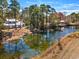 A large pond is surrounded by mature trees, providing a picturesque view of the home at 144 Springfield Rd., Pawleys Island, SC 29585