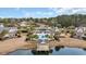 Aerial view of the neighborhood pool, lake and surrounding landscape. Palm trees and lush landscaping throughout at 155 Huntington Lake Circle # 124, Pawleys Island, SC 29585