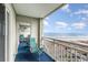 Relaxing balcony with seating offers stunning beach and ocean views at 1581 S Waccamaw Dr. # 402, Garden City Beach, SC 29576