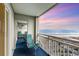 Relax on this balcony with views of the beach, equipped with seating for tranquil moments at 1581 S Waccamaw Dr. # 402, Garden City Beach, SC 29576