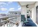 Relaxing balcony featuring comfortable seating and a glimpse of the community pool below at 1581 S Waccamaw Dr. # 402, Garden City Beach, SC 29576