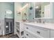 Modern bathroom with dual sinks, elegant fixtures, a glass enclosed cabinet, and tile surround at 1581 S Waccamaw Dr. # 402, Garden City Beach, SC 29576