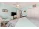 Comfortable bedroom with a queen bed, ceiling fan, desk, and a built-in closet at 1581 S Waccamaw Dr. # 402, Garden City Beach, SC 29576