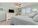 Relaxing bedroom featuring a queen bed, television, and balcony access with ocean views at 1581 S Waccamaw Dr. # 402, Garden City Beach, SC 29576