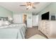 Bedroom with a large bed, ceiling fan, TV, ensuite bathroom, and plenty of closet space at 1581 S Waccamaw Dr. # 402, Garden City Beach, SC 29576