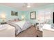Comfortable bedroom with a queen bed, ceiling fan, desk, and shuttered window at 1581 S Waccamaw Dr. # 402, Garden City Beach, SC 29576