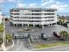 Exterior of a modern condo building with ample parking and landscaped surroundings near the beach at 1581 S Waccamaw Dr. # 402, Garden City Beach, SC 29576