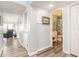 Bright hallway with wood-look flooring, leading to a bathroom and living area with ocean views at 1581 S Waccamaw Dr. # 402, Garden City Beach, SC 29576