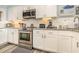 Modern kitchen with white cabinets, updated appliances, and granite counters perfect for any chef at 1581 S Waccamaw Dr. # 402, Garden City Beach, SC 29576