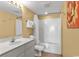 Well-lit bathroom with shower-tub, single sink vanity, and decorative wall art at 1706 S Ocean Blvd. # 1001, North Myrtle Beach, SC 29582
